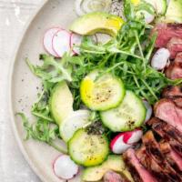 Beef Cucumber Salad · Juicy beef on a bed of fresh and locally grown greens, tomatoes, cucumbers, green peppers, g...