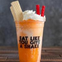 Orange Creamsicle Float · Orange soda and vanilla ice cream topped with whipped cream, vanilla wafer cookies, twizzles...