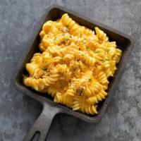 Mac & Cheese · Pasta tossed in a creamy cheese sauce topped with breadcrums and parsley