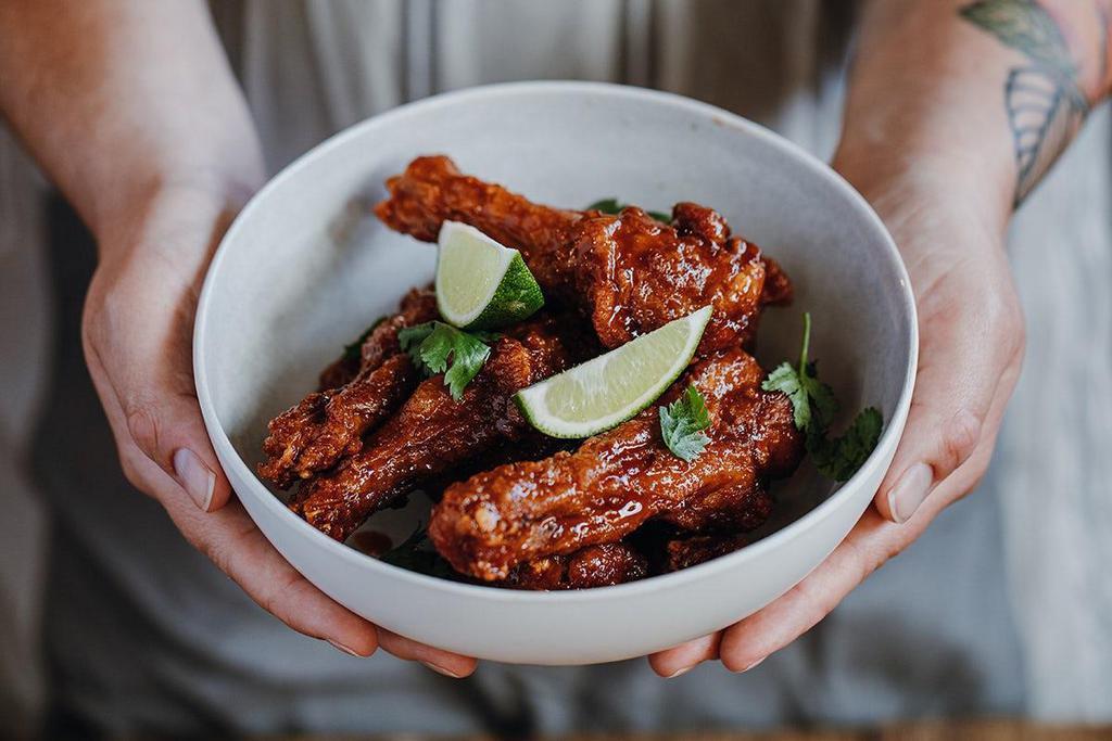 Duck Wings · Six duck wings, sweet smoky glaze, hatch chili ranch, . cilantro, lime.