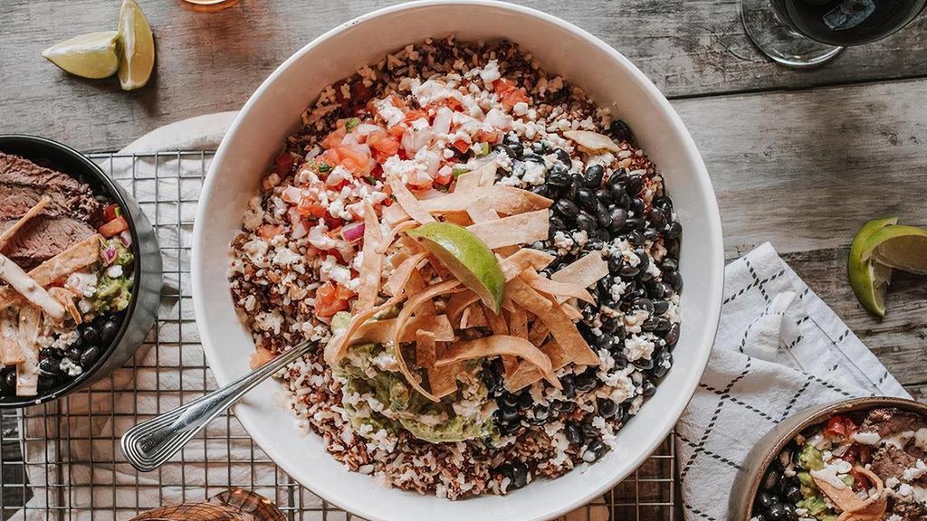 Southwest Bowl Party Pack · Guacamole, black beans, pico de gallo, sour beer queso fresco, tortilla strips, hatch chile ranch, lime with a choice of cauliflower rice or ancient grains mix..