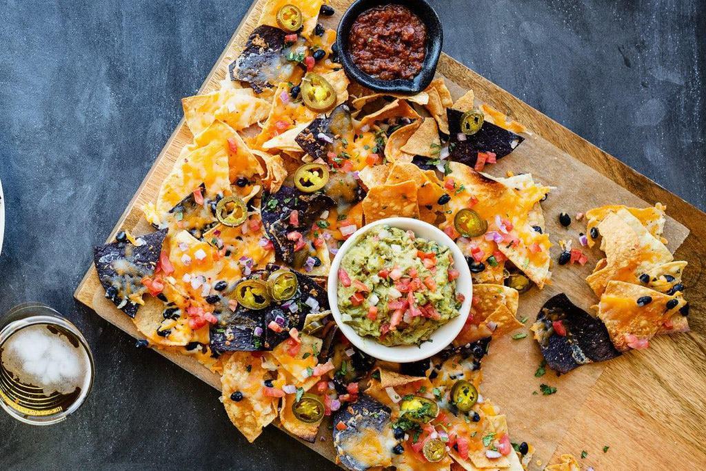 Loaded Af Nachos · Choice of santa fe chicken or beef, house-made tortilla chips, brewery queso, chipotle cream, black beans, cheddar + pepper jack, pico de gallo, pickled jalapeños, cilantro, house-made salsa, sour cream.