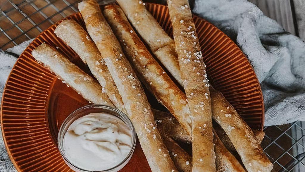 HOMEMADE PRETZEL STICKS · Half-dozen homemade pretzel sticks, pretzel salt, malt aioli.