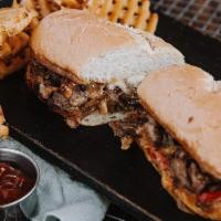 Philly Cheesesteak · Shaved sirloin, american + pepper jack cheese, grilled onions and peppers.