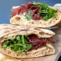 Valtellina · House-cured Bresaola (beef prosciutto) with crescenza soft cheese, arugula, and olive oil in...