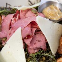 Tirolese · Thinly sliced house-made pastrami over a bed of red frilly greens, roasted pumpkin seeds, dr...
