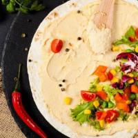 Strictly Hummus Wrap · Homemade hummus filled inside a soft lavash bread with fresh tomatoes and pickled turnips.