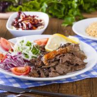 Halal Lamb Gyro Plate · Classic lamb gyro served with french fries, homemade hummus, and your choice of salad on the...