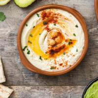 Hummus · Homemade mix of fresh chickpeas and garlic, mixed with lemon juice and tahini sauce, and top...