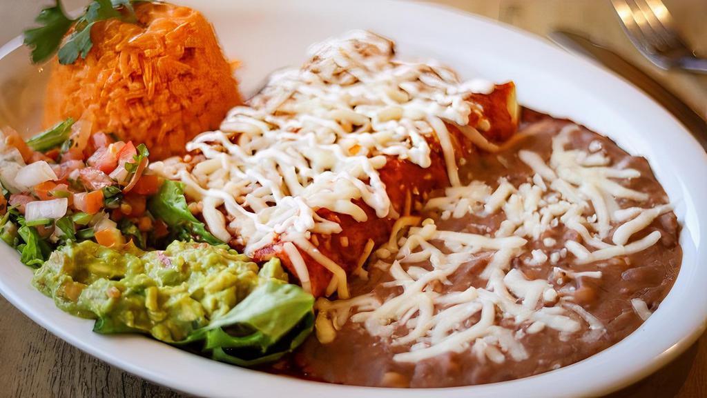 ENCHILADAS ROJAS $18 · Two enchiladas topped off with a savory red salsa stuffed with your choice of chicken or cheese with a side of rice & beans.