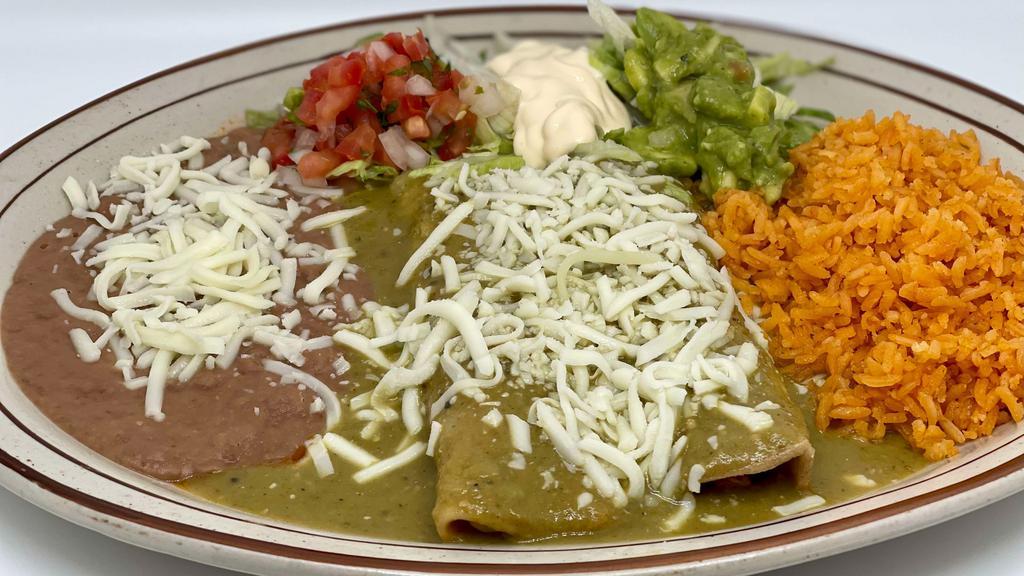 ENCHILADAS VERDES $18 · Two enchiladas topped off with a savory green salsa stuffed with your choice of chicken or cheese with a side of rice & beans.