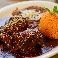 PLATO DE MOLE DE POLLO $18.99 · Two pieces of juicy chicken thighs topped with our savory mole served with your choice of co...