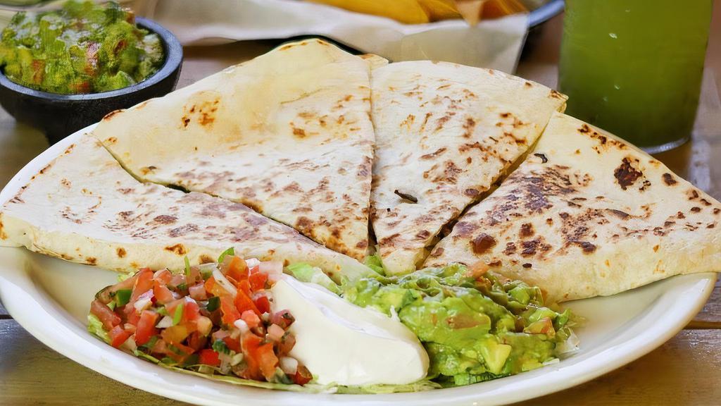 Quesadilla Los Cuates $9 · A toasty flour tortilla stuffed with cheese and your choice of meat served with a side of lettuce, Pico de Gallo, guac and sour cream.