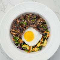 L.A. Kalbi Bibimbap · Ginger soy marinated short ribs chargrilled over carrots, zucchini, yellow squash, kale, red...