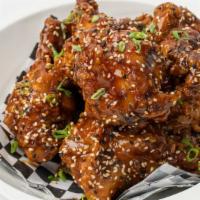 Ginger Soy wings · Double fried jumbo party wings tossed in a ginger sesame soy glaze.