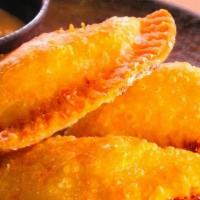 Empanadas de pollo · crispy pastry filled with shredded chicken in a Peruvian sauce, served with parsley aioli.
