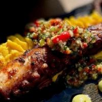 Pulpo anticuchero · grilled octopus glazed with anticuchera sauce, served with Peruvian corn & rocoto aioli