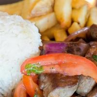 Lomo saltado · Traditional Peruvian style beef tenderloin, red onion, tomatoes, cilantro, garlic, soy and o...