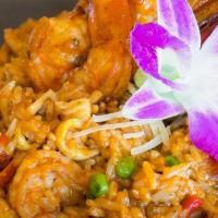 Arroz con mariscos · Fresh seafood in fried rice with aji panca & yellow pepper sauce, green peas, bell peppers, ...