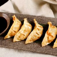 Gyoza (6 Pieces) · Pork and cabbage potstickers.