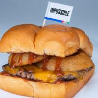 The Onion Ringer · Impossible Patty (plant based) Cheddar cheese, onion rings, BBQ sauce.