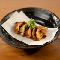 Gyoza · 5pcs deep fried juicy Gyoza topped with spice energy boost and green onion. Enjoy with soy s...