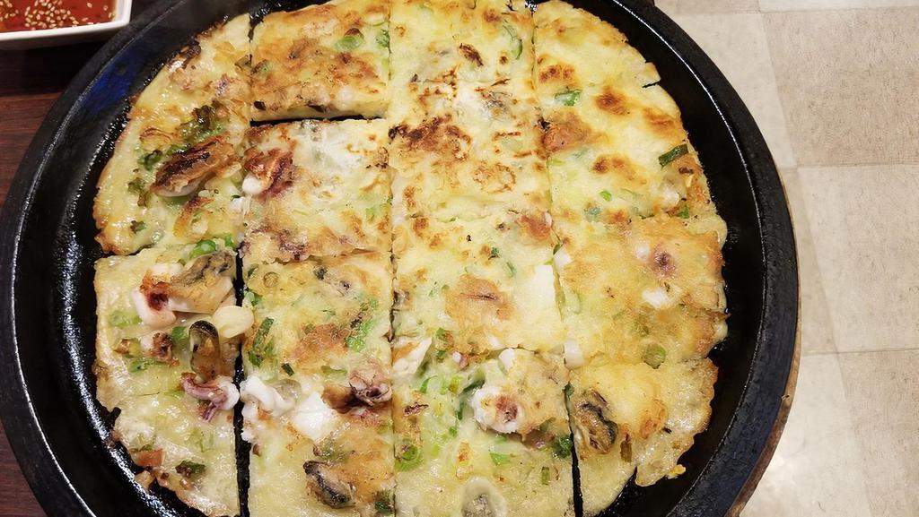 5.  Pan Fried Seafood Pancake · Pan fried pancake with shrimp, squid, scallop, clam, mussels, and green onion.