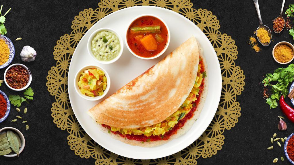 Victory Vijayawada Special Dosa · Savory crepe made of rice & lentil batter topped off with a house special Spicy Sauce, Upma, Onions, Cilantro, Cheese, Ghee and crushed Peanuts