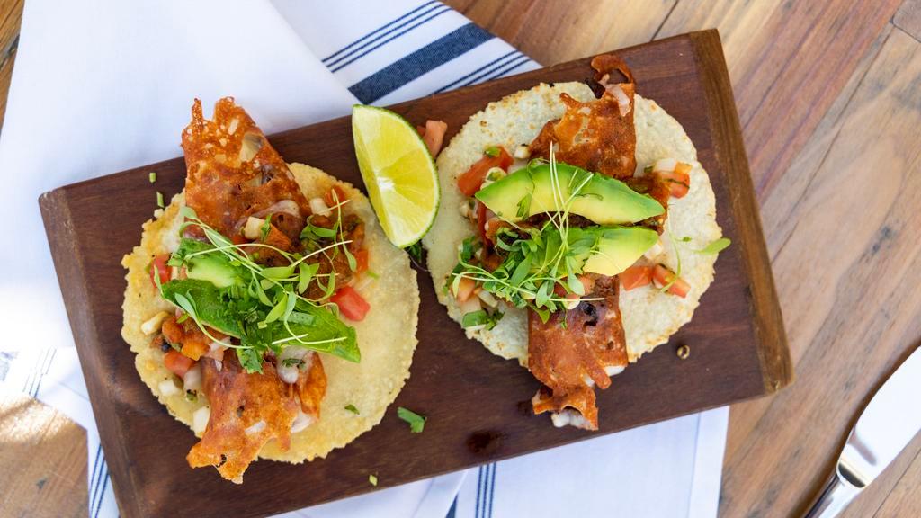 Tacos al Pastor (2) · Sliced pork meat, corn tortilla, tomatillo and avocado salsa, cilantro, onions, and pineapple.