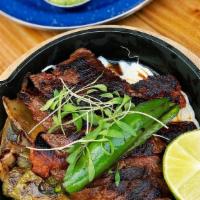 La Carnita asada · grilled skirt steak, grilled Mexican chorizo, cactus, onions, quesillo, Condiments on the si...