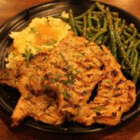 Charbroiled Pork Chop · WITH GARLIC SAUTED GREEN BEANS, . MASHED POTATOES AND GRAVY.