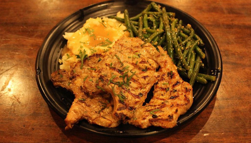 Charbroiled Pork Chop · WITH GARLIC SAUTED GREEN BEANS, . MASHED POTATOES AND GRAVY.