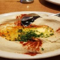 Fatteh Hummus · Toasted pita, topped with hummus, yogurt garlic sauce and toasted nuts. Does not come with p...