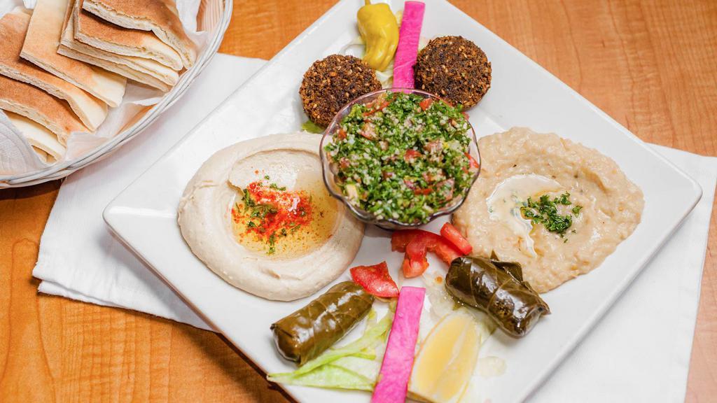 Veggie Plate · Served with pita bread. Hummus, baba ganouje, tabbouli, two falafels and two dolmas.