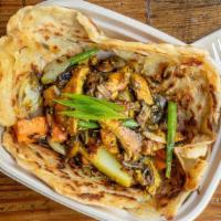 Roti Comfort · Crispy Roti topped with tossed mix veggies, soy tofu  herbs and spices.