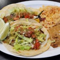 16. Shrimp Taco Plate · Two shrimp tacos made with veggies, lettuce, salsa verde and pico de gallo. With rice and be...
