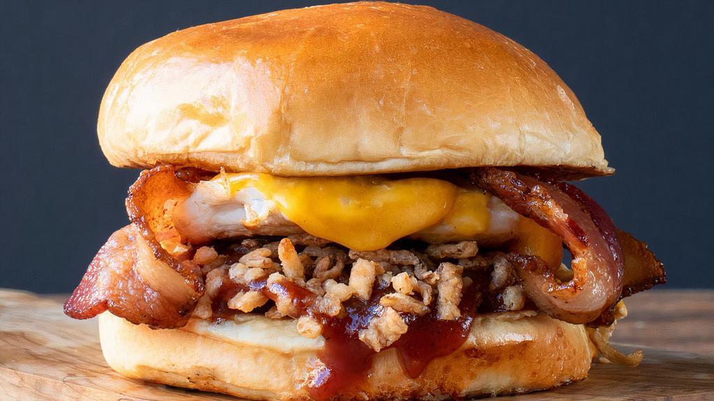 BBQ Bacon Chicken · A juicy, seasoned chicken breast with melted cheddar, smoked bacon, crispy onions, Memphis style BBQ sauce, all topped with a toasted, artisan bun.