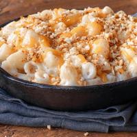 Melty Mac · Our custom cheese blend melted to creamy brilliance, topped with cheddar and toasted bread c...