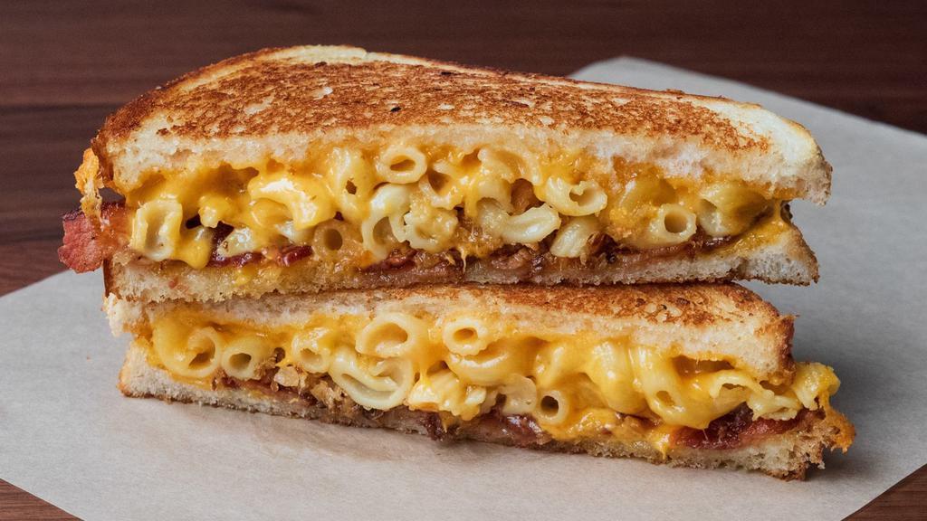 Mac Daddy Cheese · Creamy mac ‘n’ cheese, aged cheddar, smoked bacon on artisan french bread. Includes pickle on the side.