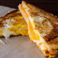 Egg-In-A-Hole · A cage-free egg nestled in our Three Cheese Classic