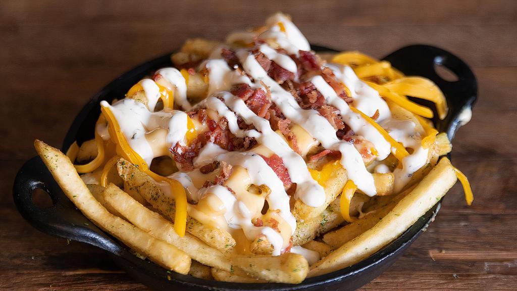 Cheddar Bacon Fries · Smothered in our cheddar sauce, crispy bacon, shredded cheddar, and ranch.