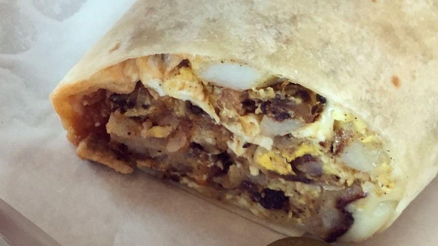 Breakfast Burrito · Includes: bacon and ham with eggs, potatoes, peppers, onions and cheese in a flour tortilla with side of salsa.