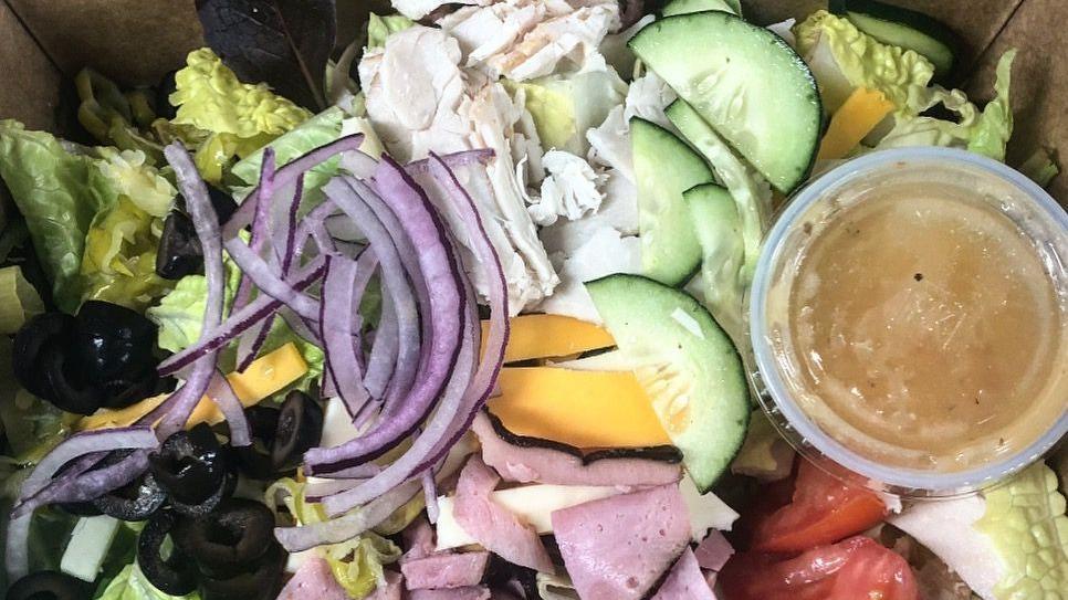 Chef Salad · Served on a bed of greens with tomato, cucumber, olives, red onion, pepperoncini, ham, turkey and cheese.