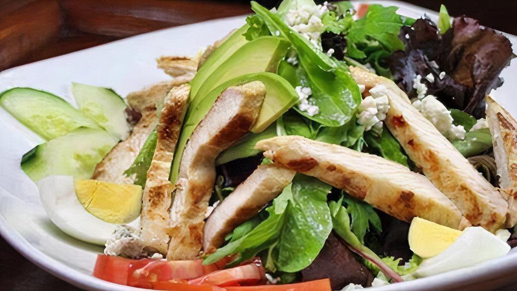 Cobb Salad · Mixed greens topped with chopped bacon, avocado, chicken breast, tomatoes, hard-boiled egg, Bleu cheese crumbles, and ranch dressing.