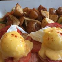 Smoked Salmon Benedict · Grilled smoked salmon, tomatoes and poached eggs on a toasted English muffin with Hollandais...