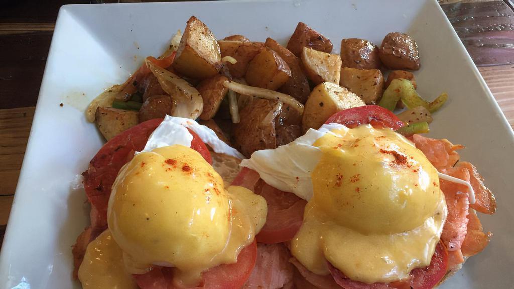 Smoked Salmon Benedict · Grilled smoked salmon, tomatoes and poached eggs on a toasted English muffin with Hollandaise sauce. Served with home fried potatoes or fruit cup.