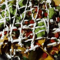 Nachos · Tortilla chips topped with melted Jack and Cheddar cheeses, beans, sour cream, guacamole, pi...