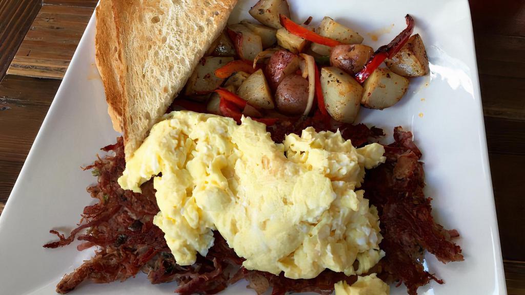 Corned Beef Hash · House-made corned beef, potatoes, scallions, herbs, and caramelized onions. Served with eggs any style, home fried potatoes, and choice of toast.