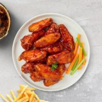 Sriracha Heat Wings · Fresh chicken wings, fried until golden brown, and tossed in butter, lemon zest, and cilantr...