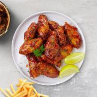 Smoked Glaze Mustard Wings · Fresh chicken wings, fried until golden brown, and tossed in smokey mustard sauce. Served wi...